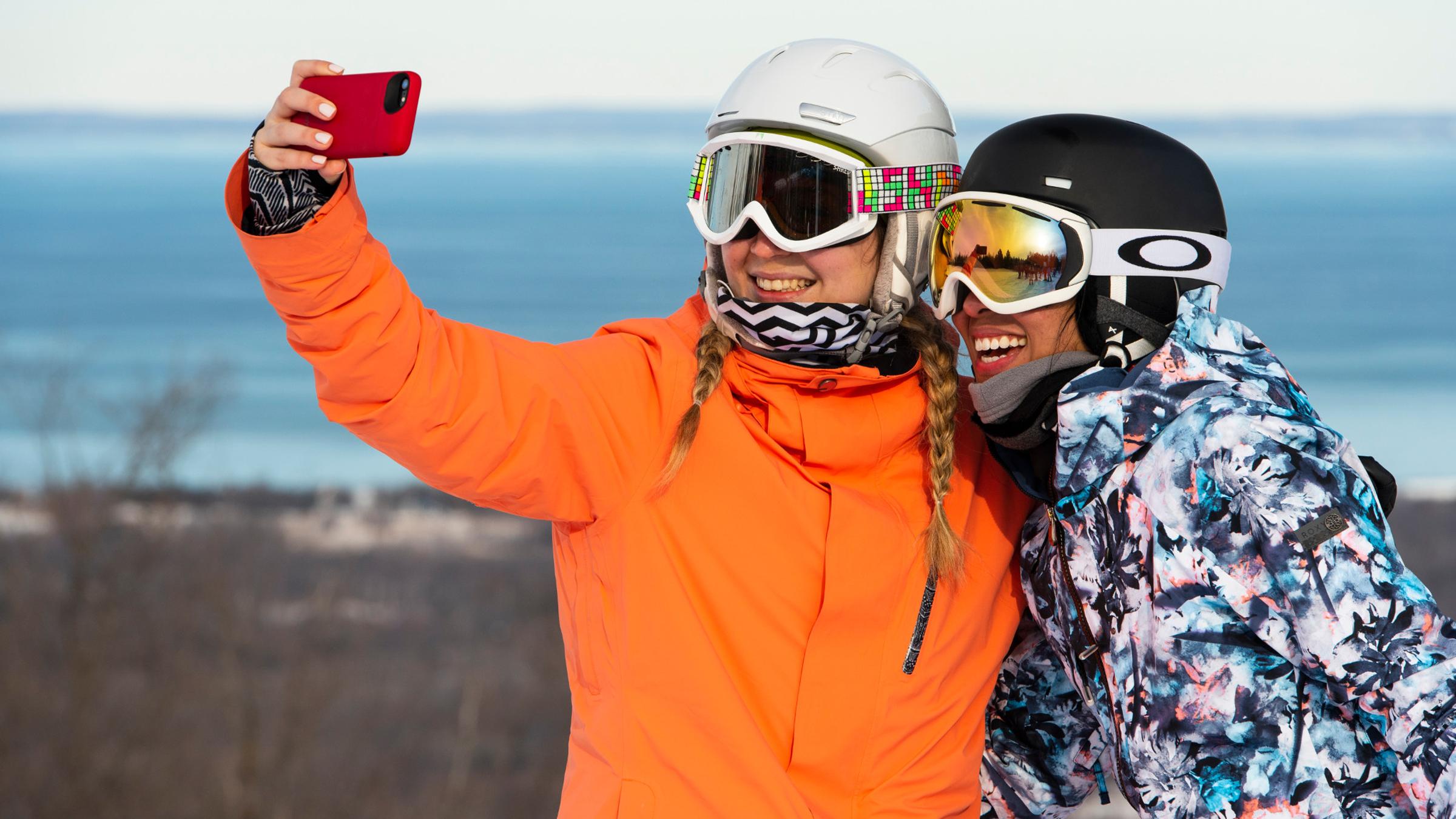 Winter lifestyle - individuals, couples and families interacting in ski and snowboard gear