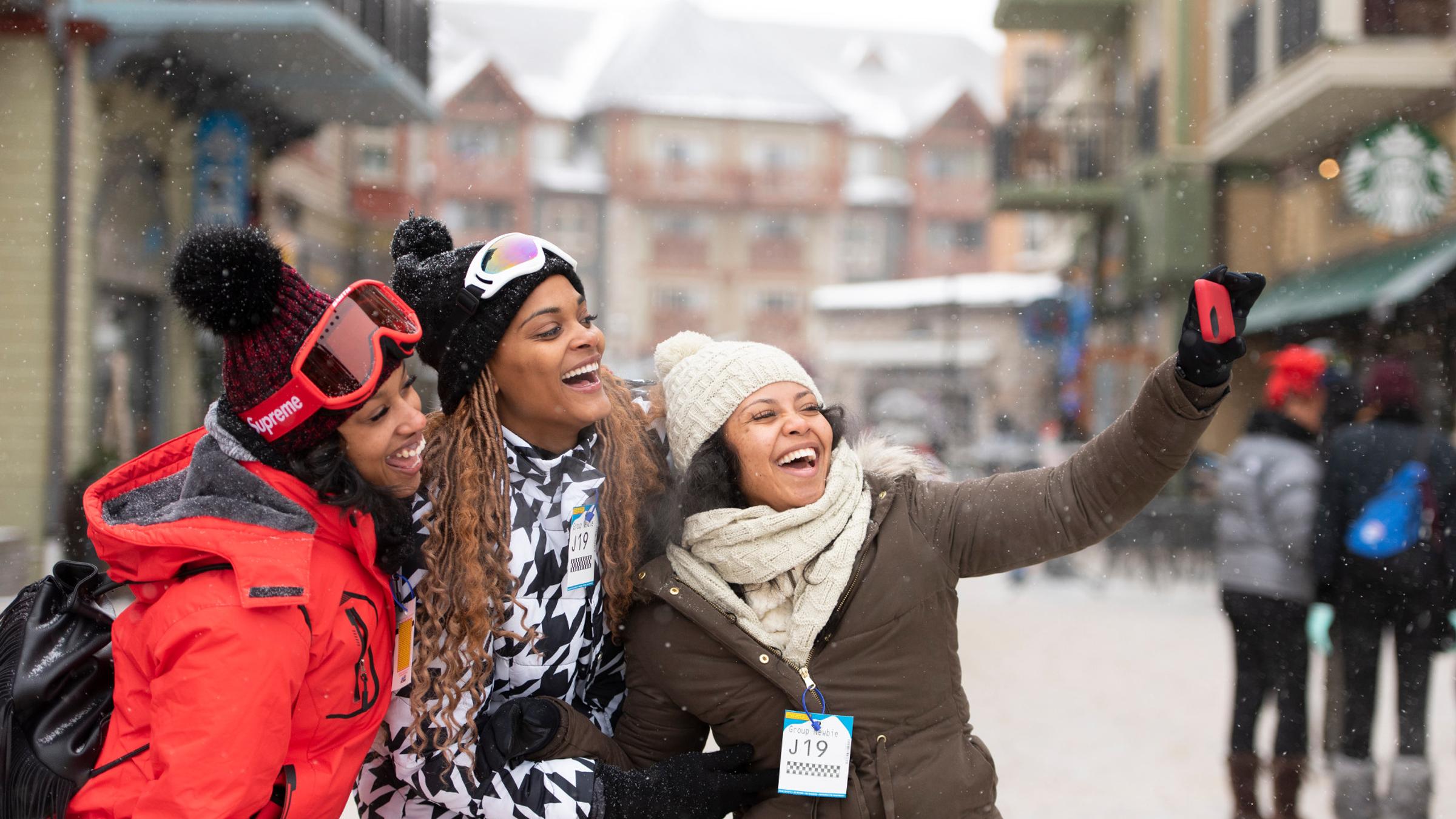 Winter lifestyle - individuals, couples and families interacting in ski and snowboard gear