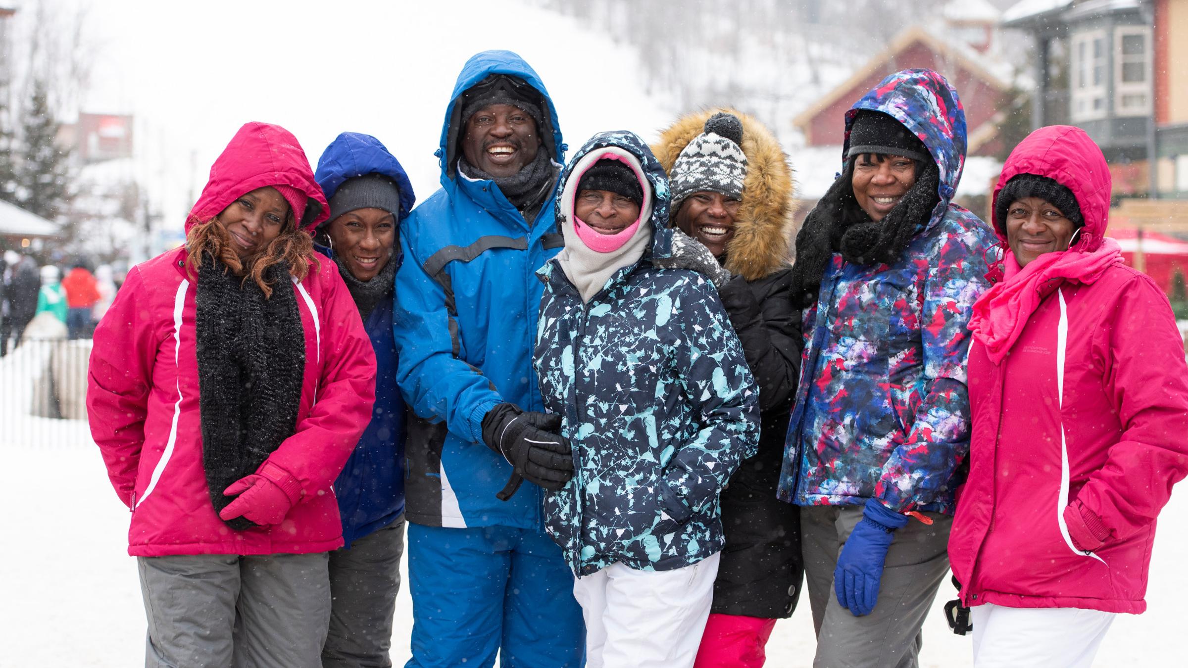 Winter lifestyle - individuals, couples and families interacting in ski and snowboard gear