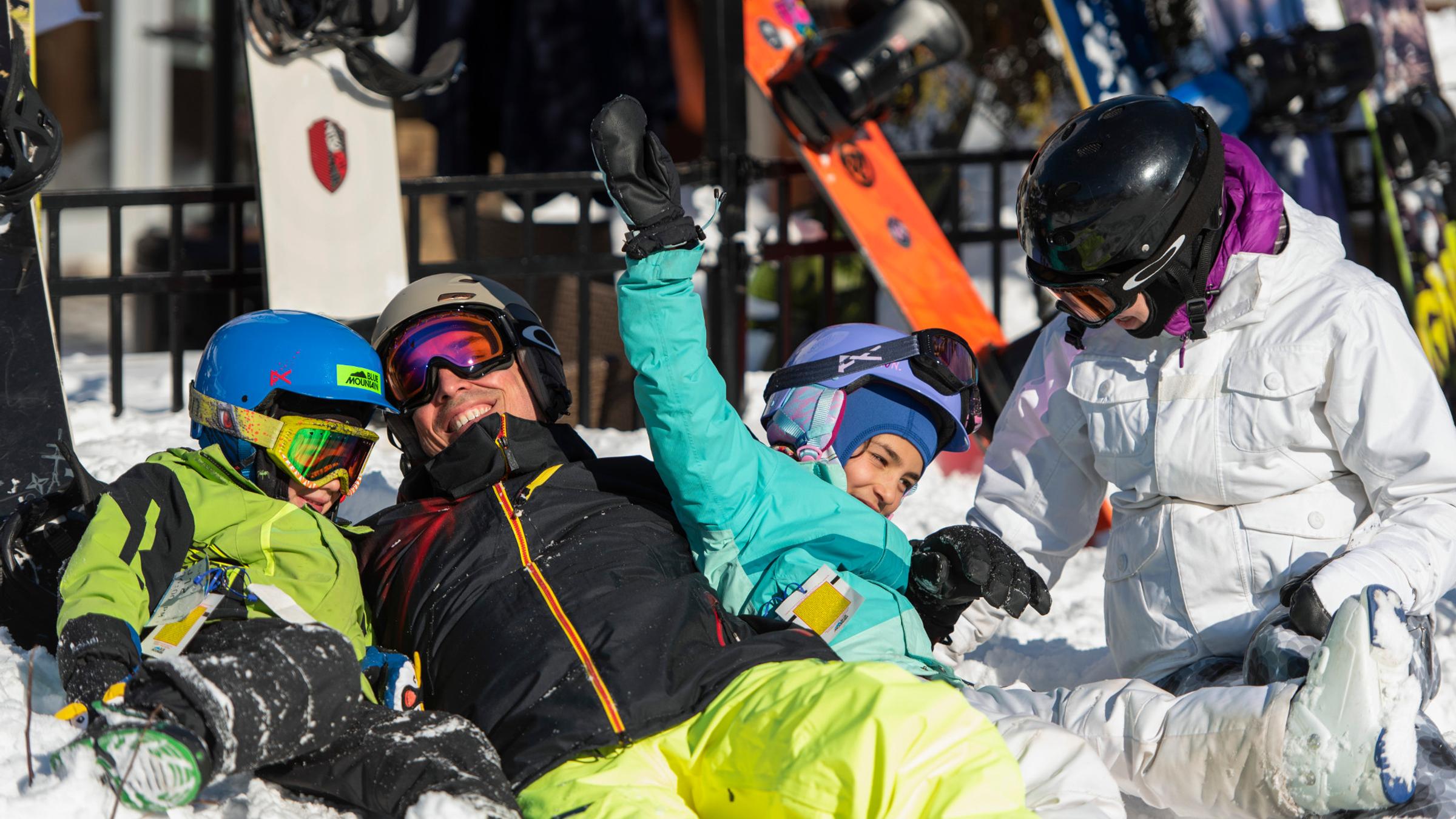 Winter lifestyle - individuals, couples and families interacting in ski and snowboard gear
